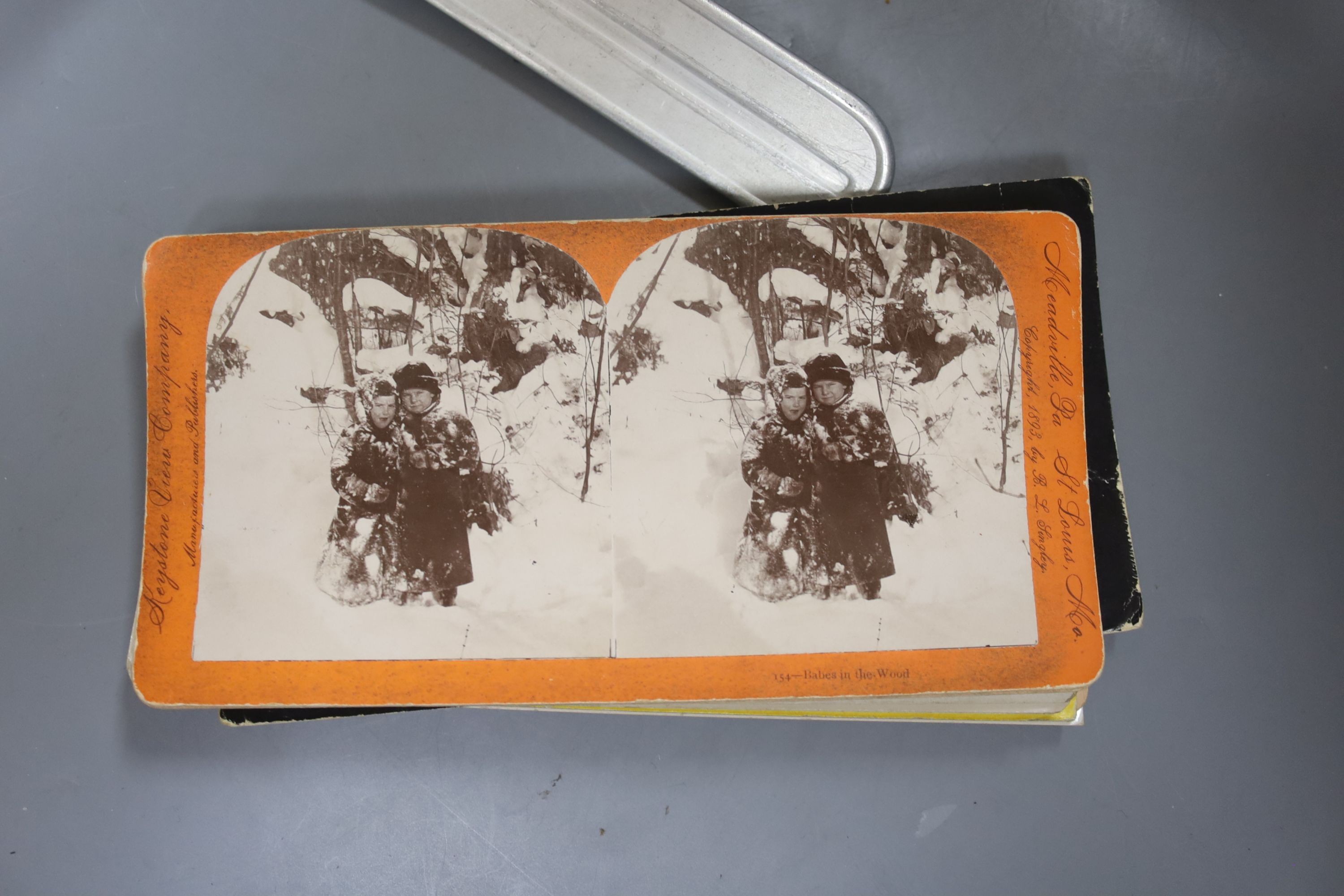 A boxed stereoscopic viewer and collection of cards, viewer 32 cms long.